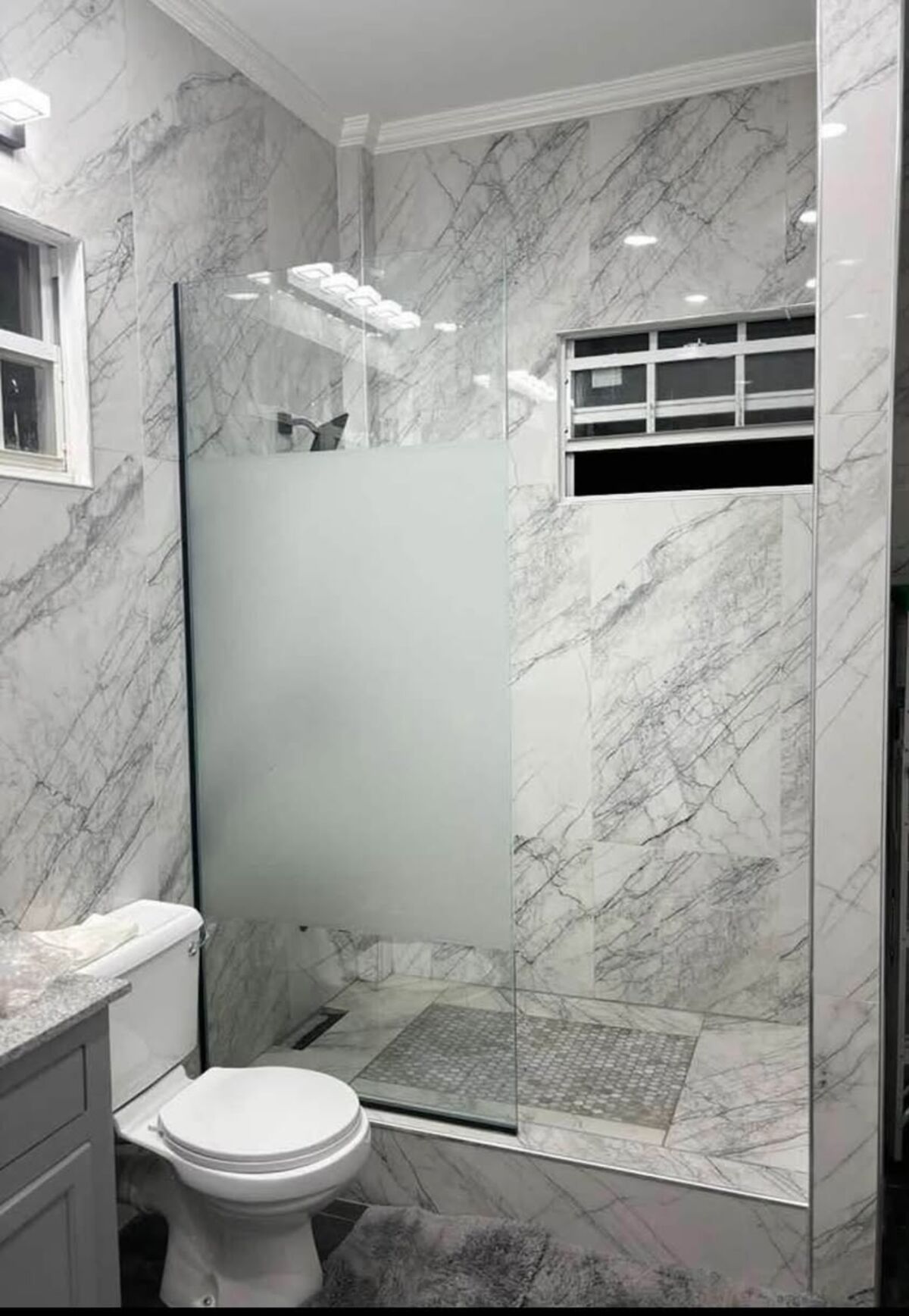 Marble bathroom with a glass shower screen